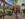 A rendering of visitors exploring the Francis J. Carey Bear Country exhibit at the Philadelphia Zoo, viewing bears through expansive glass windows and elevated pathways in a naturalistic habitat with trees, rocks, and immersive observation areas.