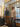 Two people with suitcases walk through glass doors into the lobby at Canopy by Hilton Philadelphia.