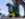 A multi-colored sculpture that says "TQ+" stands outdoors.