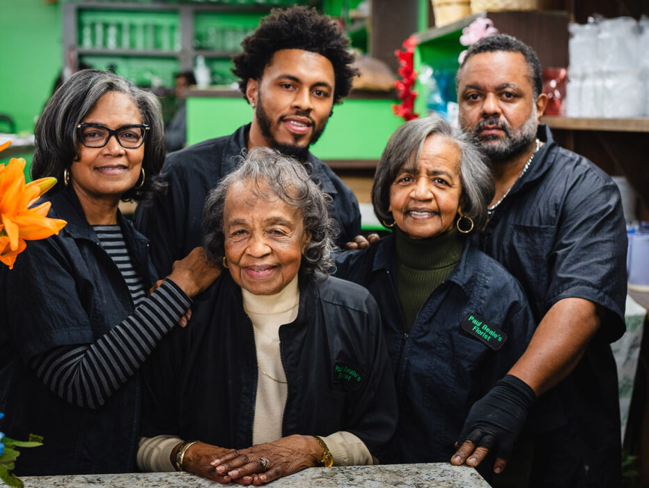 A family of florists posing for a group photo at Paule Beale's Florist