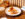 Two hash browns loaded with crab are displayed on a white plate at Little Water.