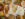 Rice, naan and a variety of Indian dishes are displayed on a table with a yellow table cloth.
