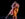 Two dancers perform an intimate duet on a dark stage, their bodies leaning together in a graceful, synchronized movement.