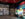 An interior view of the Philly Pride Visitor Center showing colorful displays on LGBTQ+ history, a bright welcome desk and Pride merchandise displays beneath modern circular light fixtures.