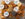 A wire basket filled with assorted freshly baked bagels—plain, sesame, everything, and poppy seed—topped with several containers of PopUp Bagels cream cheese.