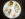A white plate holds an elegant assortment of small, artfully plated bites, including an oyster, mussel, a tiny crab and delicate radish.