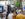 Crowds browse rows of white artist tents at the Rittenhouse Square Fine Art Show in Philadelphia, strolling along the tree-lined sidewalk while viewing paintings and artwork displays.