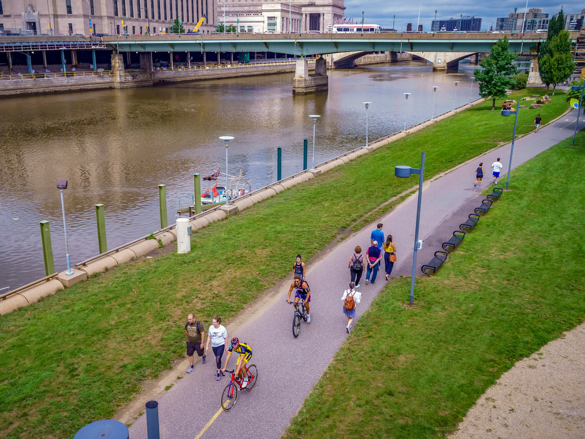 An aerial view of the Schuylkill River Trail, with runners and bikers next to the Schuylkill River