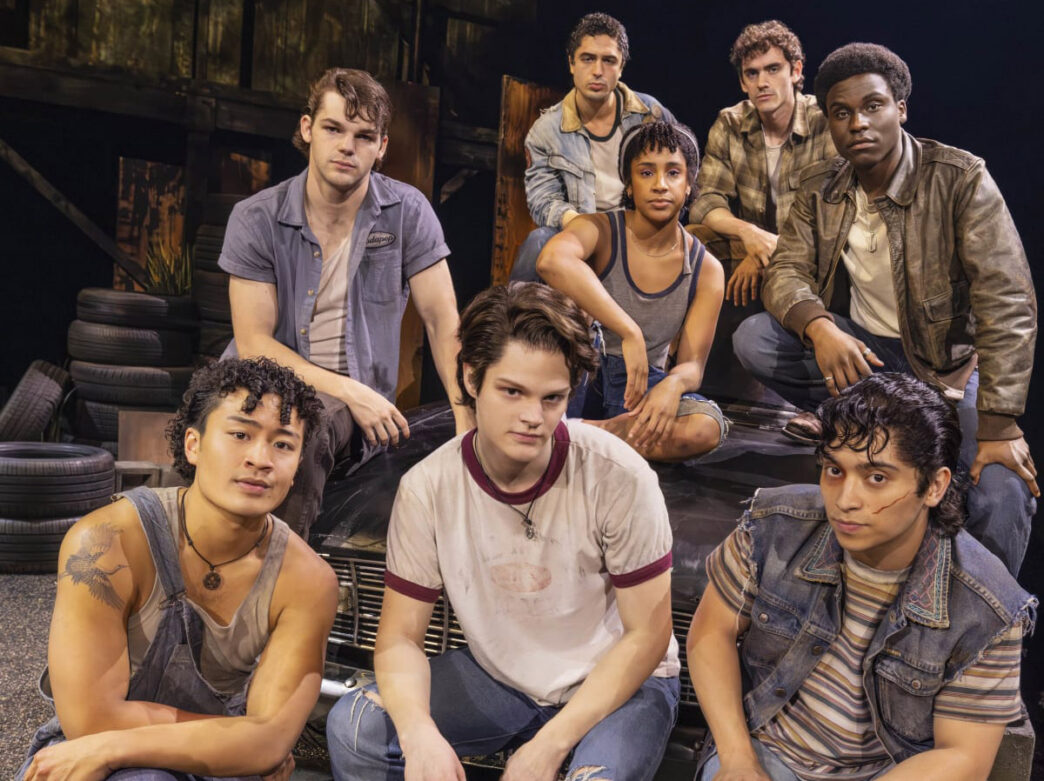 The cast of The Outsiders in denim outfits.