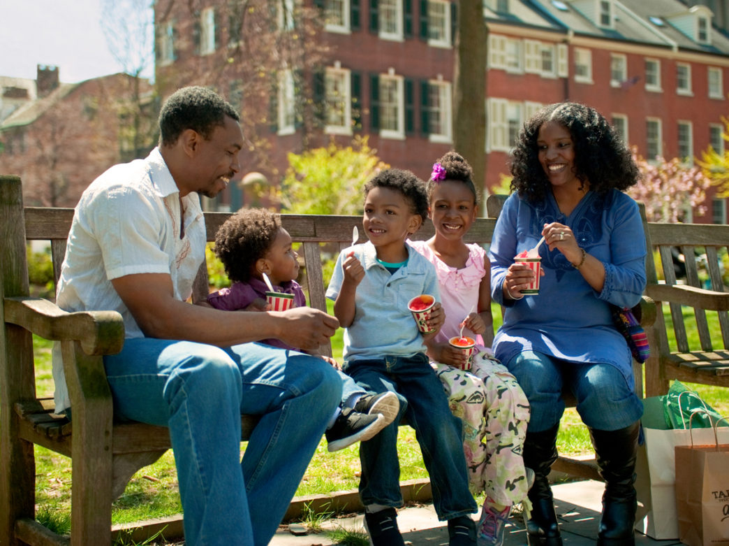 A family enjoys water ice.